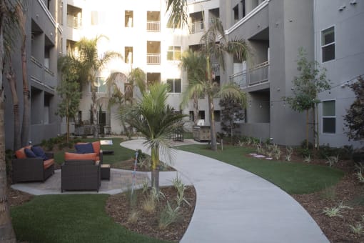 a walkway through the courtyard at the flats at big tex apartments in san antonio at The Crossings at Redlands, Redlands, CA, 92374