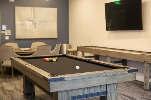 a games room with two pool tables and a flat screen tv at The Crossings at Redlands, Redlands, California