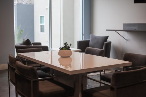 a meeting room with a table and chairs at The Crossings at Redlands, California, 92374