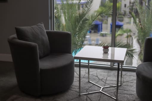 a chair and a coffee table in front of a window at The Crossings at Redlands, California, 92374