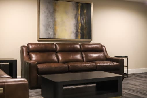 a living room with leather couches and a coffee table at The Crossings at Redlands, Redlands, CA, 92374