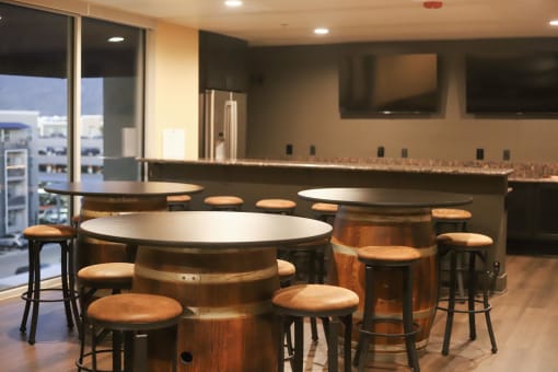 a bar area with stools and tables at The Crossings at Redlands, California, 92374
