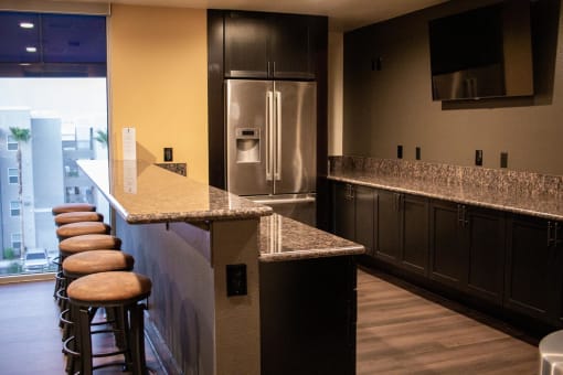 a kitchen with granite countertops and stainless steel appliances at The Crossings at Redlands, Redlands