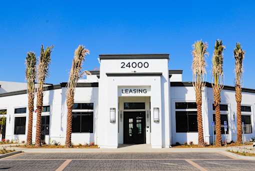 A white building with the number 24000 on it and the word "LEASING" on the top.