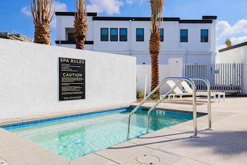 A pool with a sign that says spa rules.
