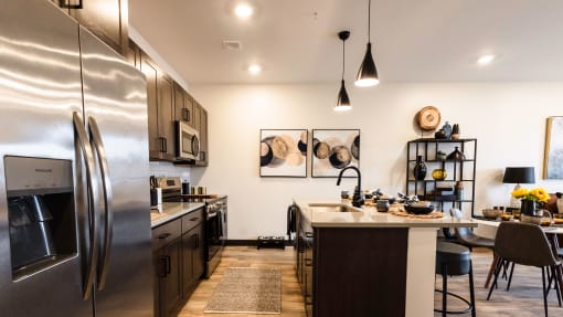 Gourmet kitchen featuring premium full-size Stainless Steel ENERGY STAR® kitchen appliances including oven range, microwave, dishwasher, garbage disposal, and refrigerator with ice maker.