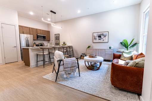 A modern kitchen with a dining table and chairs.