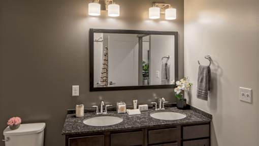 Double vanity with granite countertops in Vicina model bathroom.