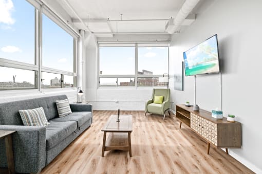 a living room with wood floors and large windows