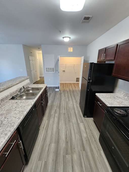Modern kitchen with a stainless steel sink  at The Assembly Apartments,  SC 29611,