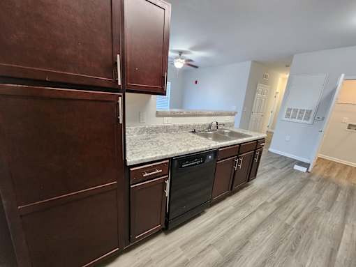 Kitchen with brown cabinets   at The Assembly Apartments, SC 29611,