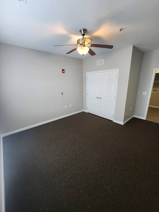 Spacious LiVing Room Area with Ceiling Fan and Closet   at The Assembly Apartments, SC 29611,
