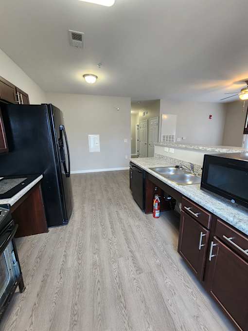 Modern Kitchen with Black Fridge  at The Assembly Apartments, Greenville