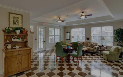 A checkered floor in a room with a table and chairs.