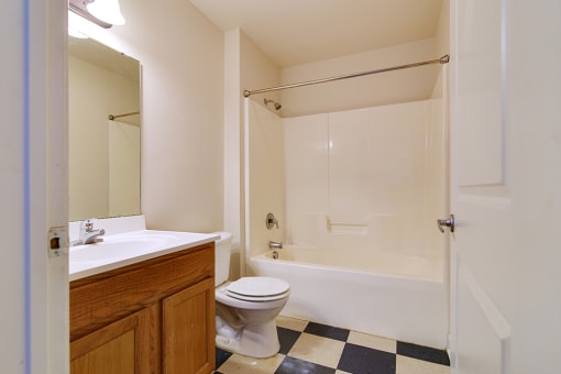 A White Bathroom with a Bathtub at Ridgecrest Apartments, Bristol, VA, 24201