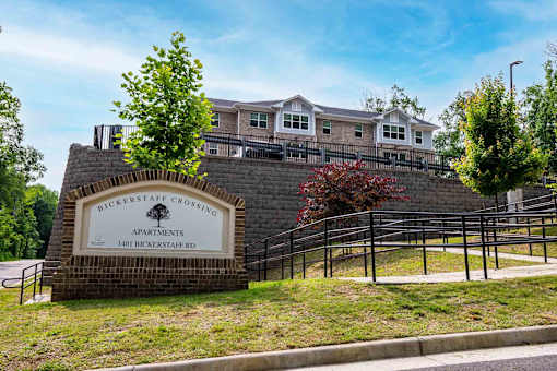 A sign for Bickerstaff Crossing Apartments stands in front of a brick wall. at Bickerstaff Crossing Apartments, Henrico, VA