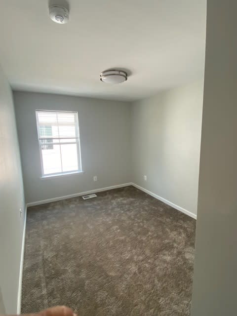 an empty room with a window and a carpet at Braddock Terrace, Aldie Virginia