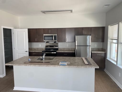 a kitchen with a counter top and a refrigerator at Braddock Terrace, Aldie