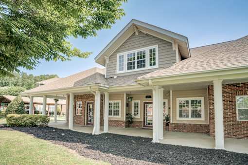 A house with a grey roof and white columns.