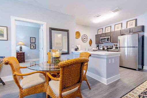 A kitchen with a dining table and chairs. at Bulls Creek, Charleston