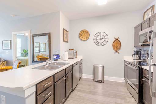 A kitchen with a white counter top and black cabinets. at Bulls Creek, Charleston