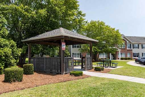 A gazebo is surrounded by bushes and a fence at Carriage Hills, Lumberton, NC 28358