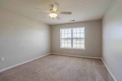 A room with a ceiling fan and carpeted floor at Carriage Hills, Lumberton, NC 28358