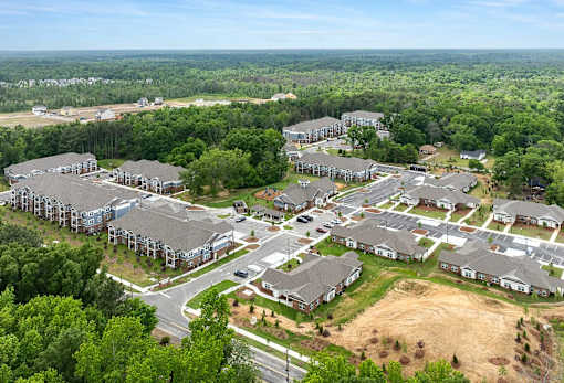 A bird's eye view of a residential area with houses and trees.