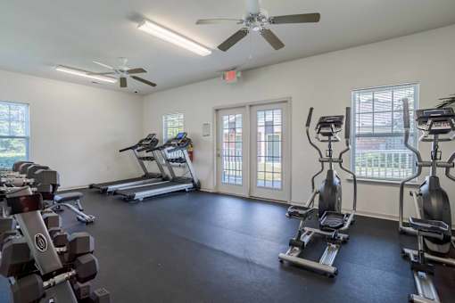 A spacious gym with treadmills, stationary bikes, and dumbbells.at Hartsville Garden Apartments, Hartsville, SC