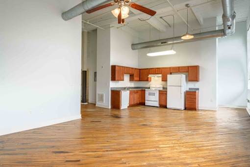 Kitchen area with wooden floors at Kemper Lofts Apartments, Lynchburg, VA, 24501