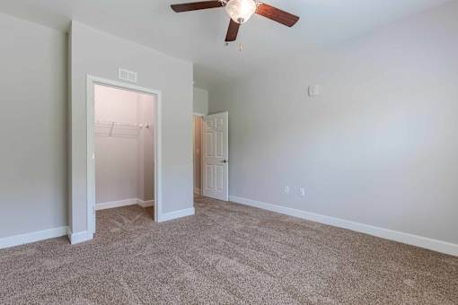 A room with a ceiling fan and carpeted floor. at Killian Terrace Apartments, Columbia, South Carolina