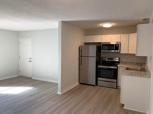 A kitchen with a refrigerator, oven, and microwave.at Summerville Garden, Summerville