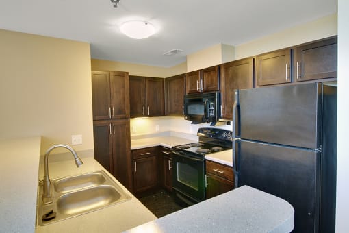 Kitchen with a sink, stove, and refrigerator at Highland Memorial, Gastonia, 28052
