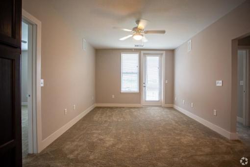 Living Room with Patio Access at Stone Springs Apartments, Sterling, VA