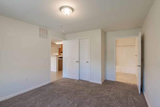 A room with a carpeted floor and white walls. at Mountain Laurel III Apartments, Staunton