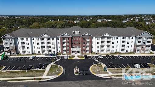 Aerial view of building with car parking at Poland Hill Senior Apartments, Chantilly
