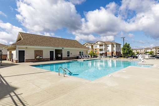 A large swimming pool in front of a building.