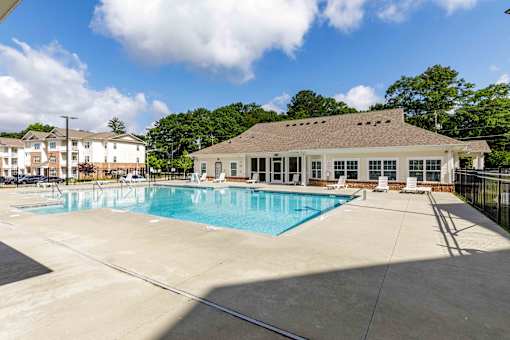 A large swimming pool with a building behind it.