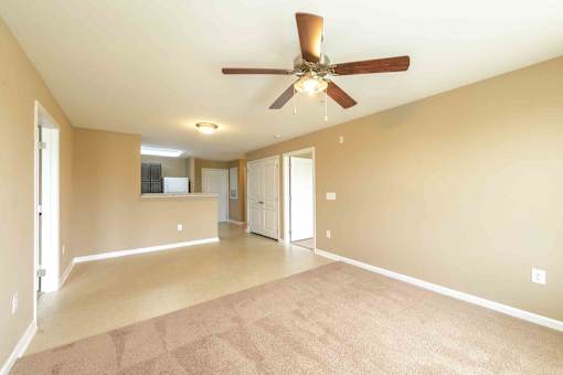 A spacious room with a ceiling fan and carpeted floor. at The Grande at Granite Falls LLC Apartments, Rolesville, NC