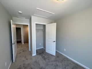 a empty room with an open door and a closet at Braddock Terrace, Aldie, VA