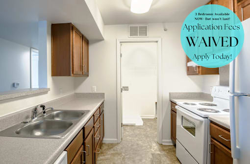 A kitchen with a sign that says "Application Fees WAIVED".