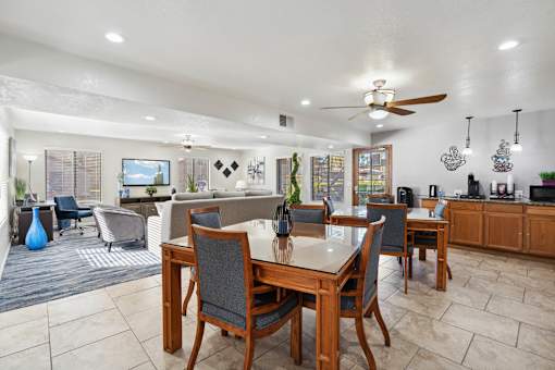 A dining room with a table and chairs.