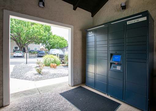 A parking garage entrance with a sign that says "Villas of QC".