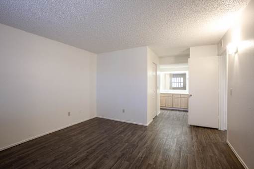 A room with wooden floors and white walls.