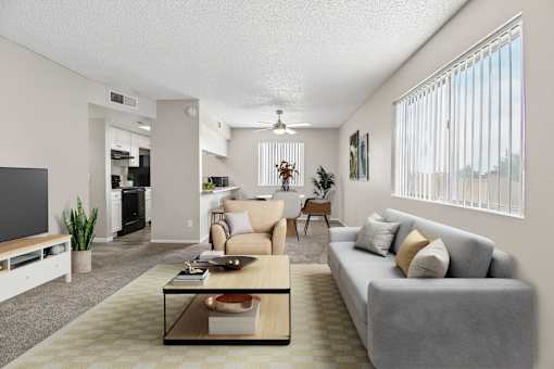 A living room with a grey couch, a wooden coffee table, and a flat screen TV.