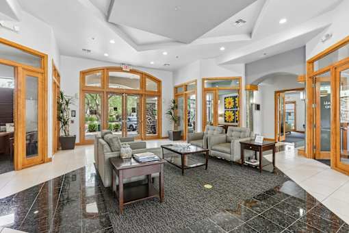 A spacious lobby with a coffee table and couches.