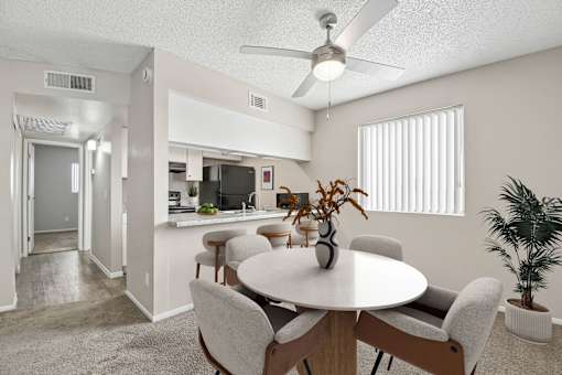 A dining room with a round table and chairs.