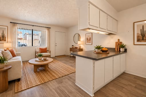 A kitchen with white cabinets and a wooden island.