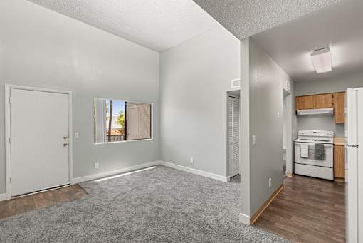 A spacious living area with a kitchenette in the back.