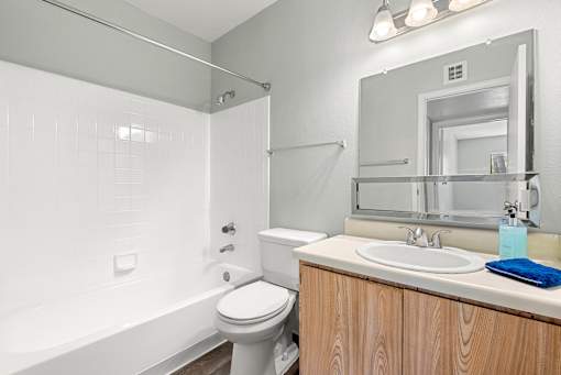 A white bathroom with a toilet, sink, and bathtub.